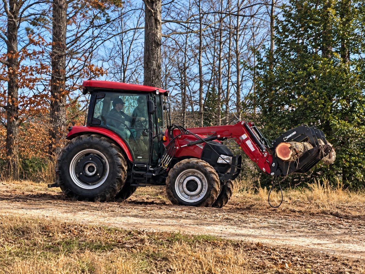 Tractor handling a sawlog at the Bloom & Buzz sawmill